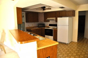 Low ceilings, outdated cabinets, and fake wood countertops, oh my!