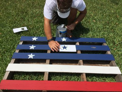 Adding stars to our pallet flag fence